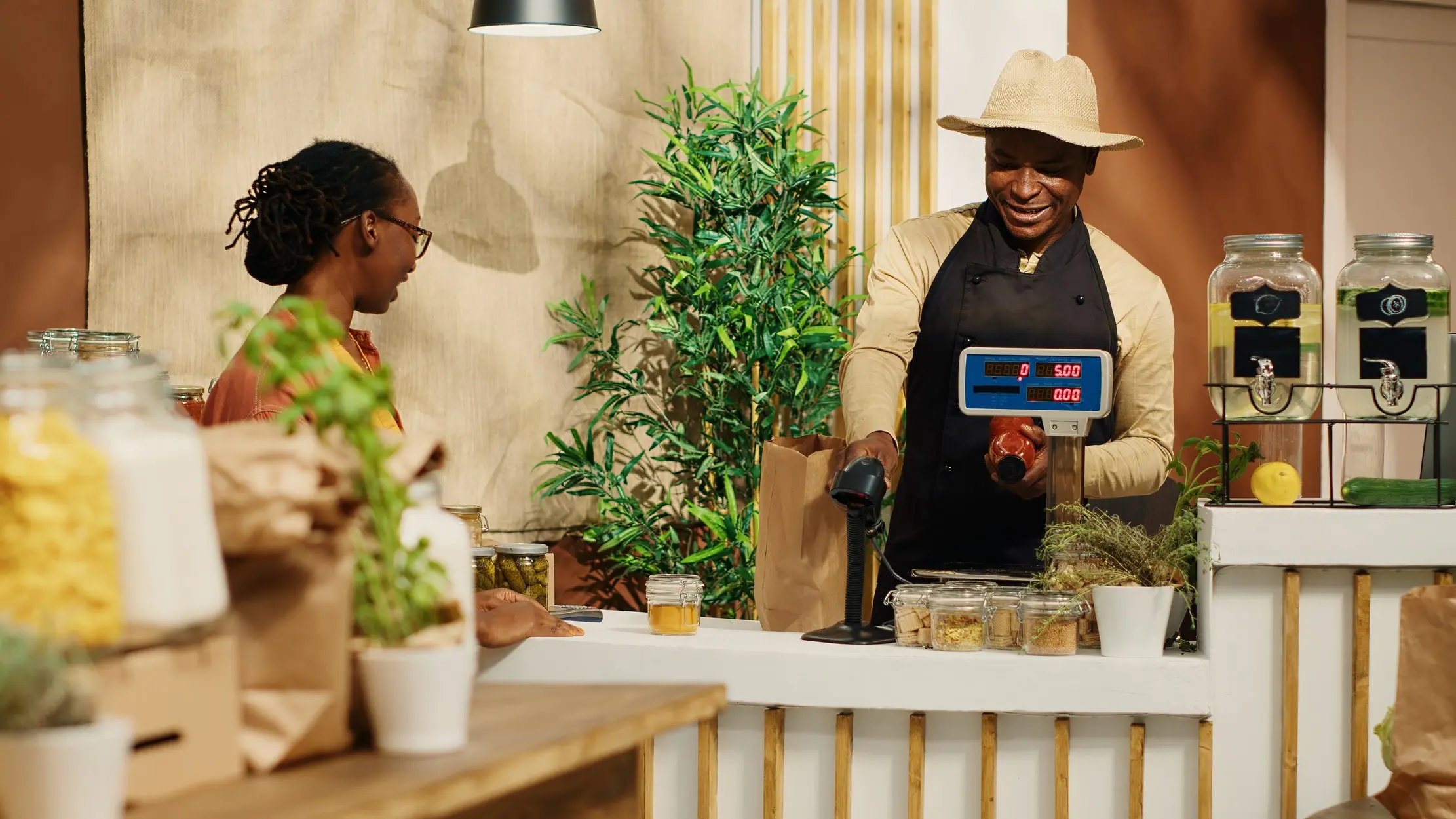 Shop attendant weighing and packing a customer order at the counter