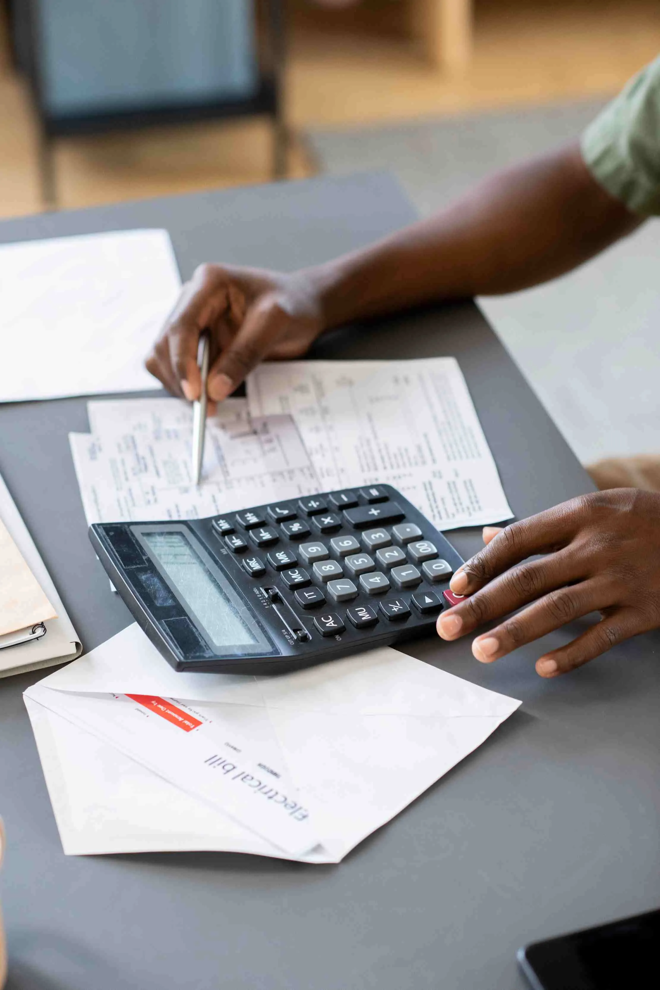 African business owner checking unpaid bills and tax payment forms
