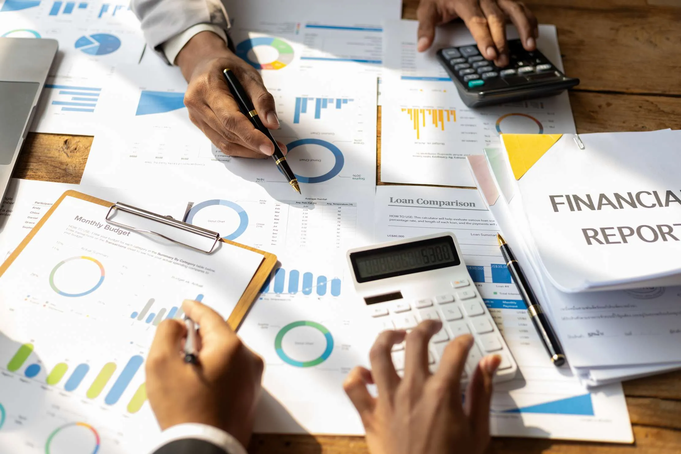 Financial advisor reviewing accounting reports and business strategy with a team