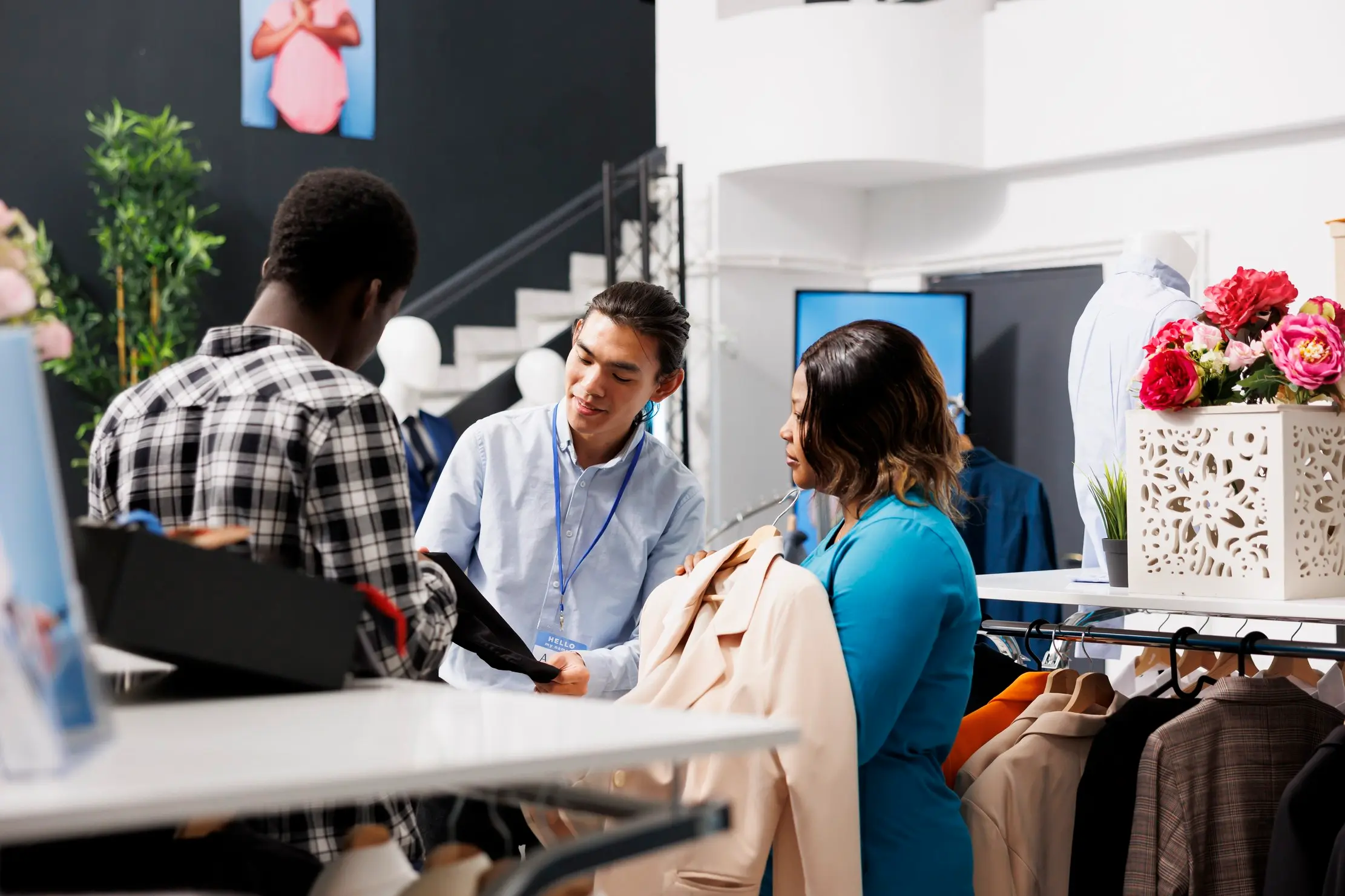 Shopper checking a shirt while an attendant needs fast product search at POS