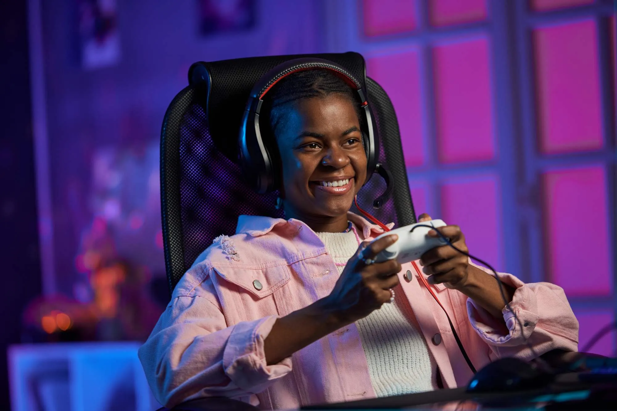 Gaming parlour customer playing video games, representing timed gaming sessions and snack sales in Maduuka
